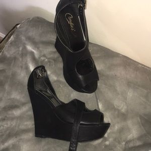 Black platform heels.  4+ inches